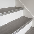 Matt silver anodised stair nosing in a flat low-sheen finish fitted to mid-grey LVT steps on an apartment landing