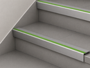 Mid grey and green slimline insert stair nosings fitted to two pale grey steps
