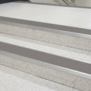Midnight grey PVC insert fitted in aluminium stair nosings on a railway station staircase