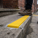 Yellow 8mm non-slip stair tread insert set into a concrete step