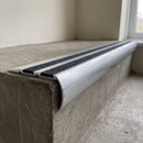 Aluminium 77x40mm carborundum stair nosing in mill finish with black carborundum anti-slip insert, fitted to a concrete step