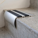 Aluminium 77x40mm carborundum stair nosing in satin finish with black carborundum anti-slip insert, fitted to a concrete step