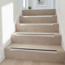 Aluminium anti-slip stair nosing in Anodised Silver with Black Insert installed on carpeted stairs