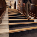 Oak effect self-adhesive aluminium stair nosing 30mm x 20mm on a hotel staircase with dark treads