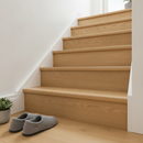 Lacquered solid oak stair nosing fitted to the edges of a light oak staircase in a British hallway