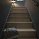 Smoked grey-brown solid oak stair nosing fitted to a dark contemporary staircase