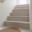 Smoked and white-oiled solid oak stair nosing fitted to a bright Scandinavian-style staircase