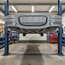 Grey anti-corrosive chassis paint freshly applied to the underbody of a commercial trailer in a UK workshop