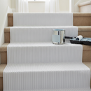White Correx floor protection sheets laid on a staircase and landing during a decorating project, protecting carpet and stair treads