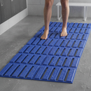 Blue anti-slip wet area matting laid in a gym shower changing room with bare feet walking on it