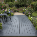 Dark grey anti-slip decking paint freshly applied to a timber deck in a UK garden with outdoor furniture