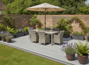 Grey composite decking boards forming a garden patio deck with outdoor dining table and chairs