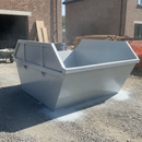 Light grey painted builder's skip freshly coated with anti-corrosive skip and container paint on a UK construction site