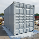 Light grey painted metal shipping container freshly coated with anti-corrosive enamel paint at a UK builder's yard