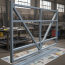 Grey anti-corrosive metal oxide primer freshly applied to a steel gate frame ready for topcoat, UK workshop setting
