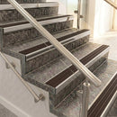 Square front aluminium stair nosings with peat brown ribbed inserts on mottled stone steps