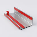Underside of an aluminium stair nosing with factory-applied double-sided adhesive strips under a red release liner