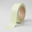 Roll of photoluminescent egress marking tape in pale yellow-green on a neutral studio background