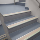 72x55mm aluminium stair nosing with a beige PVC insert and green photoluminescent strip fitted to health centre stairs