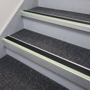 72x55mm aluminium stair nosing with a black PVC insert and green photoluminescent strip fitted along carpeted office stairs