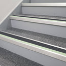 72x55mm aluminium stair nosing with a Midnight Grey PVC insert and green photoluminescent strip fitted to transport interchange stairs