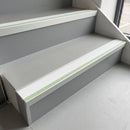 72x55mm aluminium stair nosing with a white PVC insert and green photoluminescent strip fitted to interior office stairs