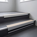 Porth Stone Smooth Textured insert in a 66x55mm square front aluminium stair nosing with 13mm black riser highlight, fitted to interior steps