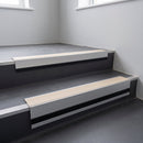 Porth Stone Smooth Textured insert in a cut to size 66x55mm aluminium stair nosing with 13mm black riser highlight, fitted to interior steps