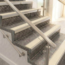 Square front aluminium stair nosings with smooth Portland stone inserts on mottled stone steps