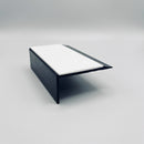 Black PVC ramped hard nose stair nosing 67x32mm on a studio background, showing the wide white anti-slip insert and the L-shaped section