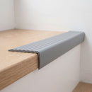 Grey flexible PVC stair nosing 40mm x 25mm fitted over the front edge of a pale oak laminate stair tread
