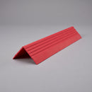 Self-adhesive PVC stair nosing 50mm x 42mm in red, shown alone on a plain studio background with the ribbed tread face visible