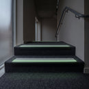 60x32mm stair nosing glowing green along each step edge in a dark stairwell during a power cut, no wiring or power needed