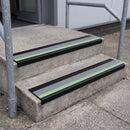 PVC stair nosing 60x32mm with dolphin grey anti-slip insert fitted to external concrete steps, green photoluminescent strip along the front edge
