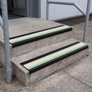 PVC stair nosing 60x32mm with white anti-slip insert fitted to external concrete steps, green photoluminescent strip along the front edge