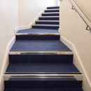 Heavy Duty Rake Back Aluminium Stair Nosing 2.75m, 62 x 56 in Mirrorflect Silver finish fitted on a commercial stair
