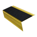 Mirrorflect Gold rake back DDA aluminium stair nosing 70 x 56mm with Coal black Exterior Grip insert, studio view showing the raked leg and ramped back