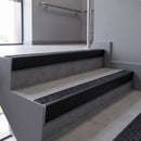 Aluminium rake back stair nosing 56 x 56mm, Coal Exterior Grip insert, Satin Black finish, fitted to concrete steps