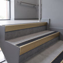 Aluminium rake back stair nosing 56 x 56mm, Coal Exterior Grip insert, Satin Gold finish, fitted to concrete steps