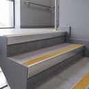 Aluminium rake back stair nosing 56 x 56mm, Brimstone Exterior Grip insert, Satin Silver finish, fitted to concrete steps