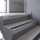 Aluminium rake back stair nosing 56 x 56mm, Obsidian Mor Grip insert, Satin Silver finish, fitted to concrete steps