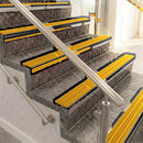 Raked back aluminium stair nosing, black anodised with gold castellated insert