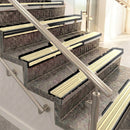 Raked back aluminium stair nosing, black anodised with ivory castellated insert