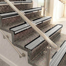 Raked back aluminium stair nosing, black anodised with light grey castellated insert