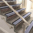 Raked back aluminium stair nosing, black anodised with nimbus castellated insert