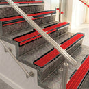 Raked back aluminium stair nosing, black anodised with poppy castellated insert