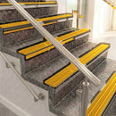 Raked back aluminium stair nosing, bronze with gold castellated insert