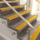 Raked back aluminium stair nosing, light bronze with gold castellated insert
