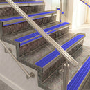 Raked back aluminium stair nosing, light bronze with mid blue castellated insert