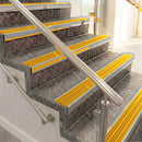 Raked back aluminium stair nosing, mill aluminium with gold castellated insert